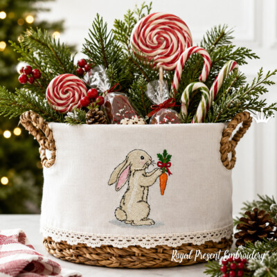 Lapin festif avec une carotte ornée d’un nœud, motif de broderie machine